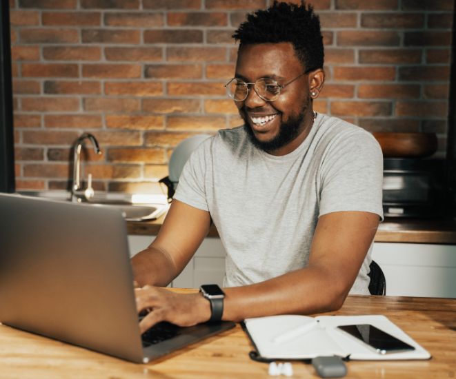 A man using a laptop in his kitchen