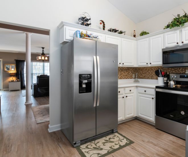 A stainless steel fridge in a modern kitchen.